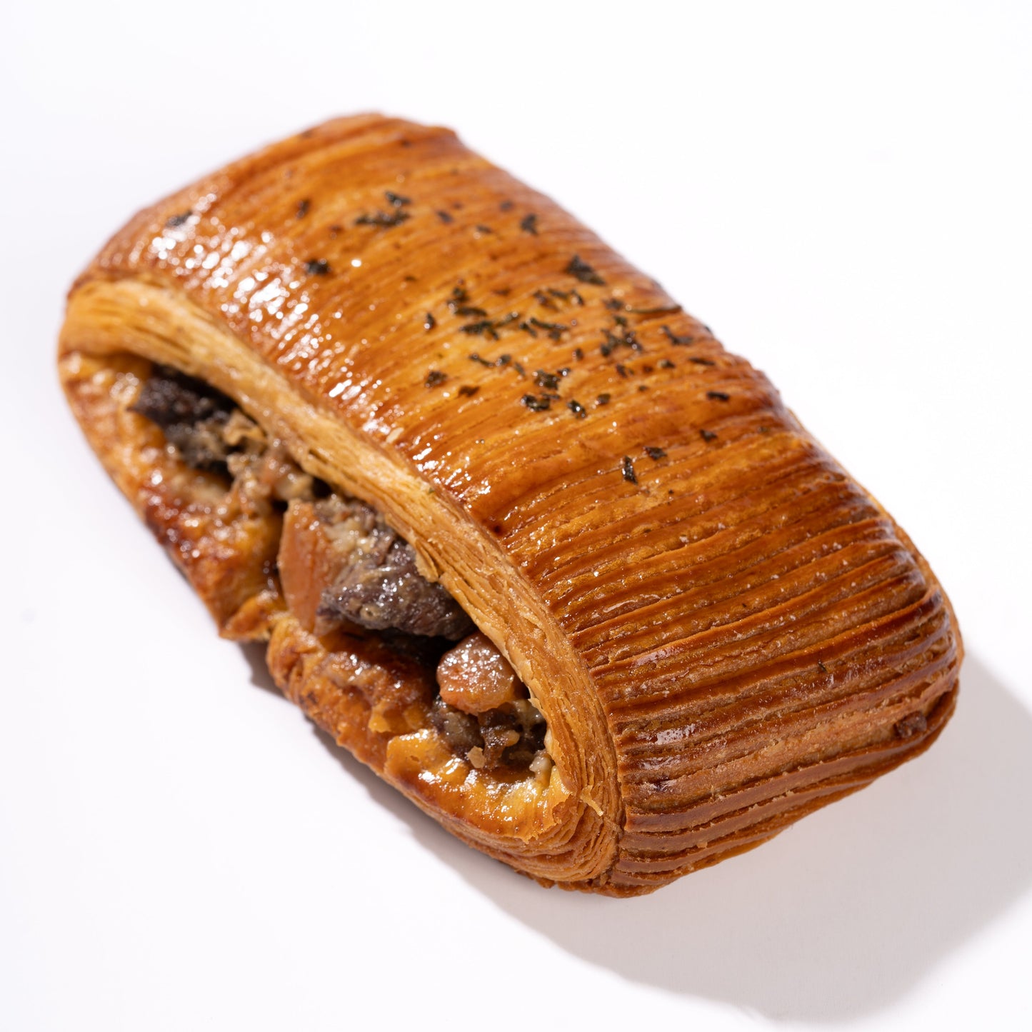 Buttery Pain Suisse croissant filled with traditional French boeuf bourguignon, tender beef, carrots and potatoes.