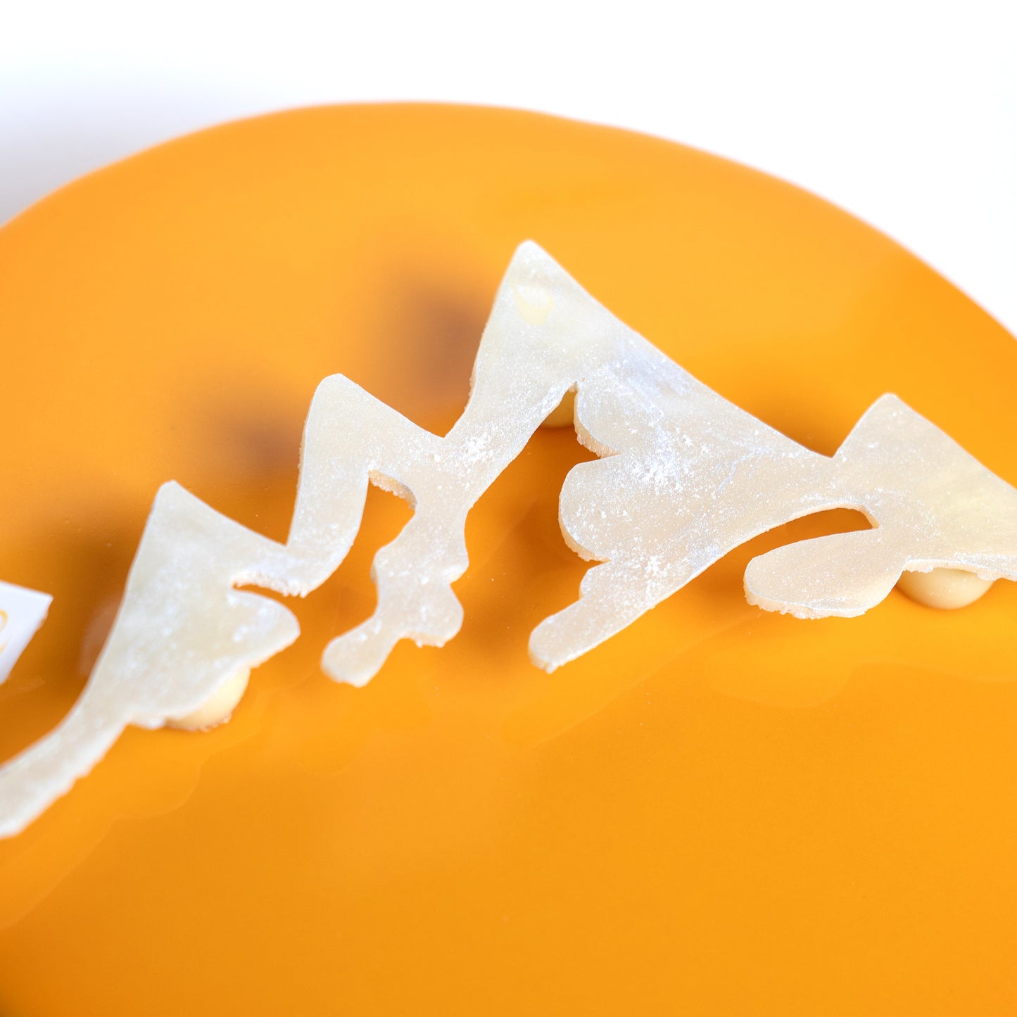 Chocolate detail of the three sisters mountain on orange cake