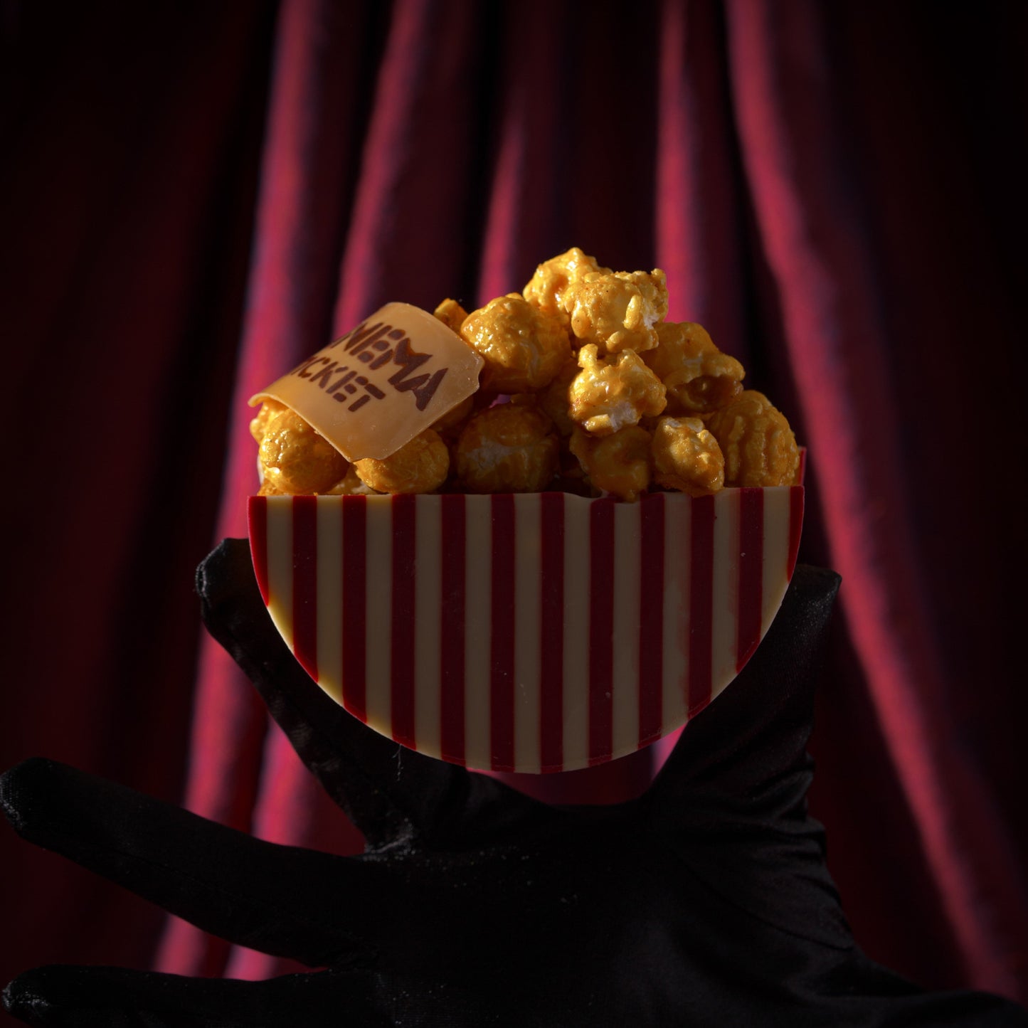 Buttery croissant roll with rich caramel filling, crunchy caramel popcorn, and white and raspberry chocolate inspired by movie nights with Dad.