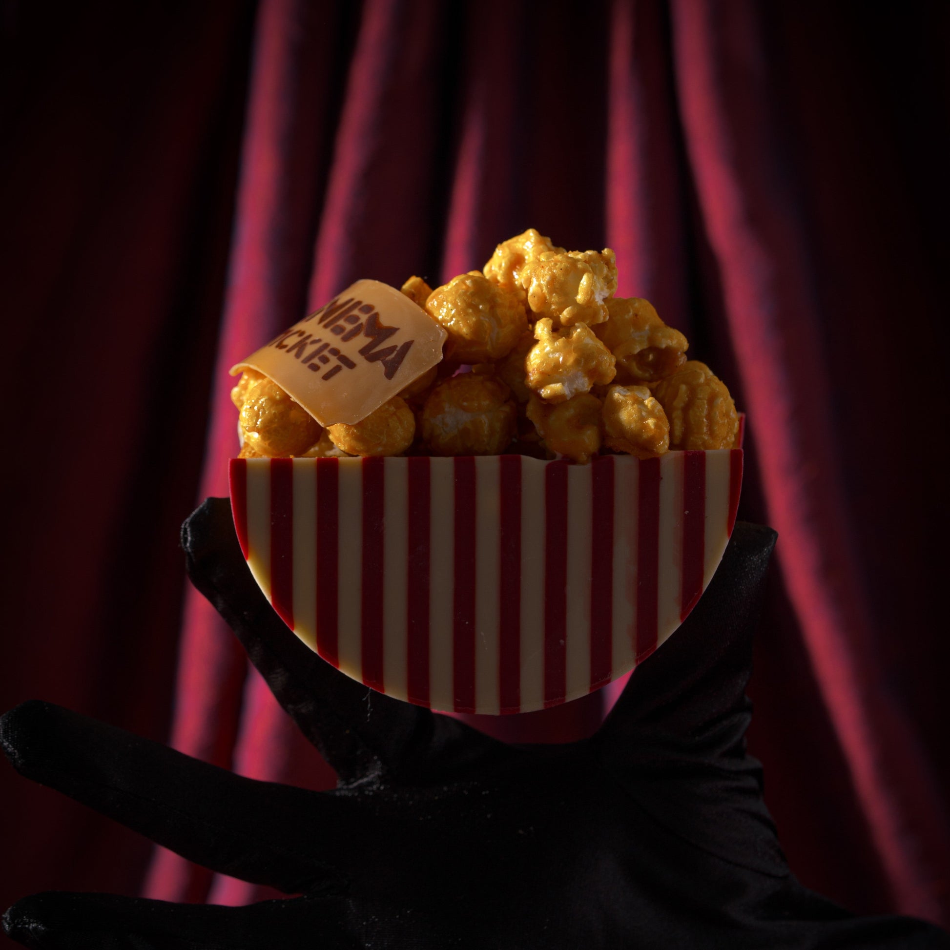 Buttery croissant roll with rich caramel filling, crunchy caramel popcorn, and white and raspberry chocolate inspired by movie nights with Dad.