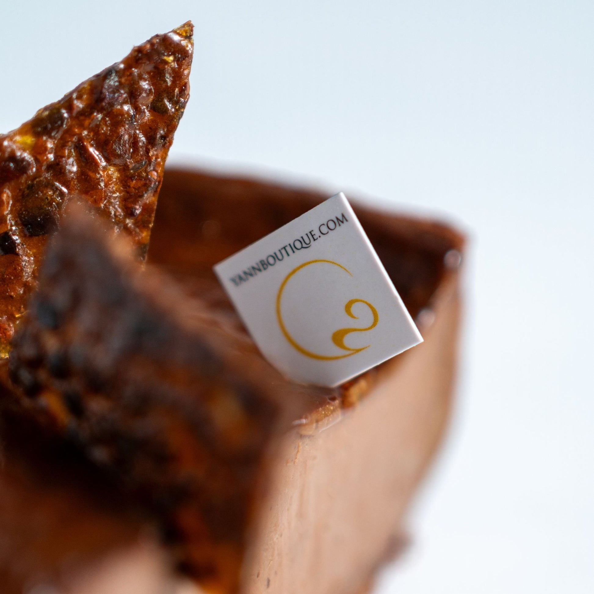 Close-up of a chocolate dessert with a small square Yann Haute Patisserie label 