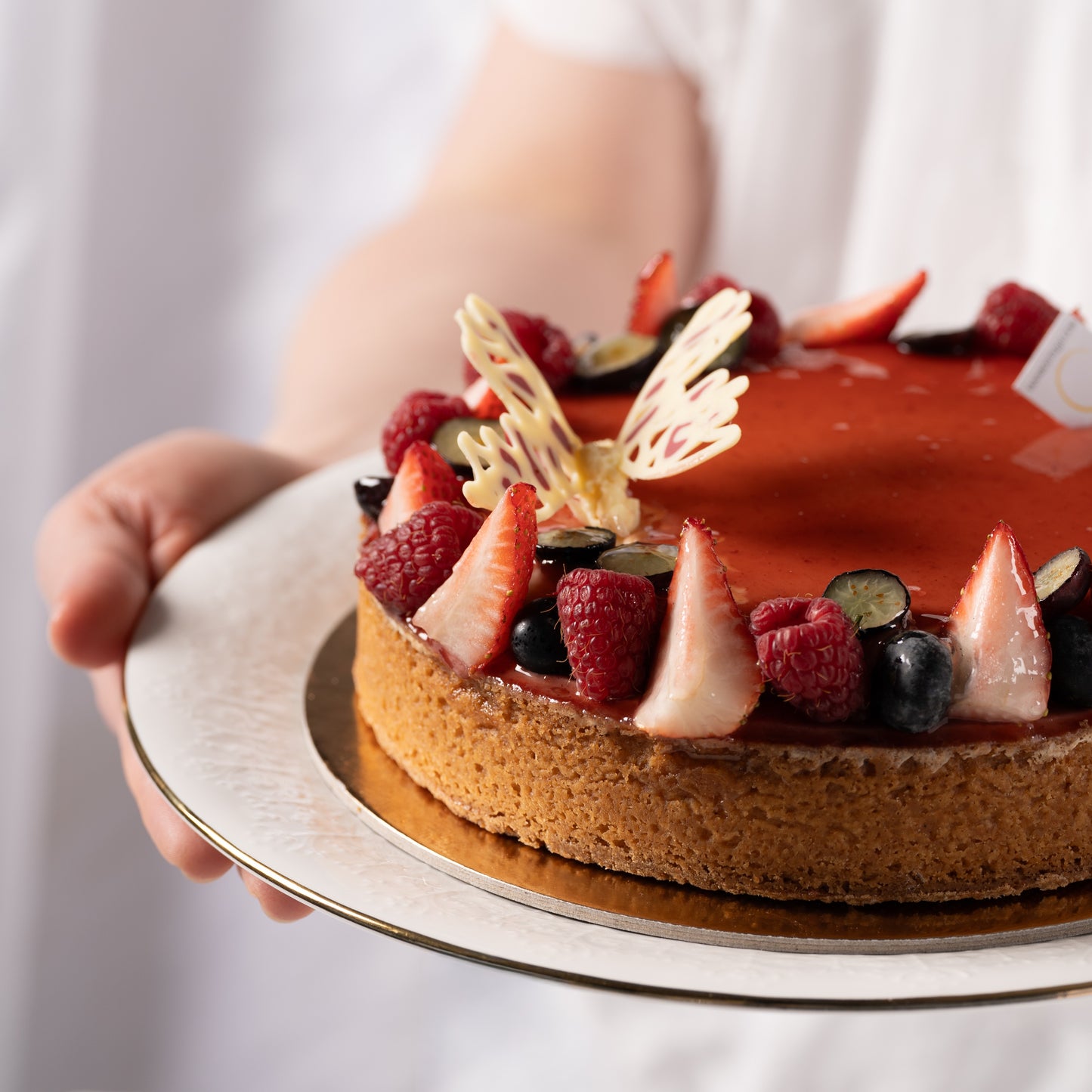 Coeur de Coco Mother’s Day dessert Calgary, raspberry and coconut tart with almond frangipane and crème brûlée, fresh strawberries and raspberries, luxury French pastry by Yann Haute Patisserie, elegant celebration cake YYC