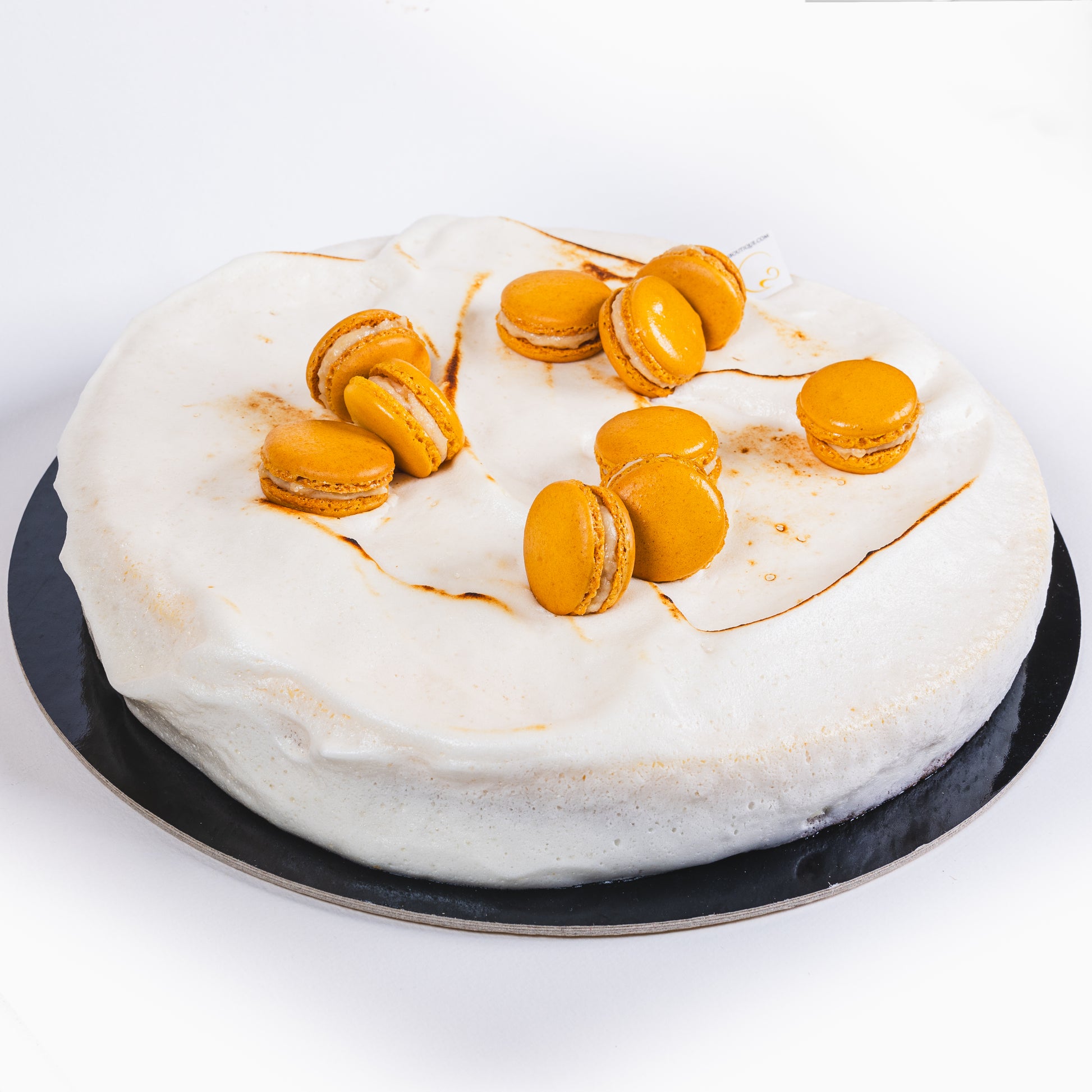 Elegant lemon tart topped with soft meringue and filled with lemon crémeux and compote