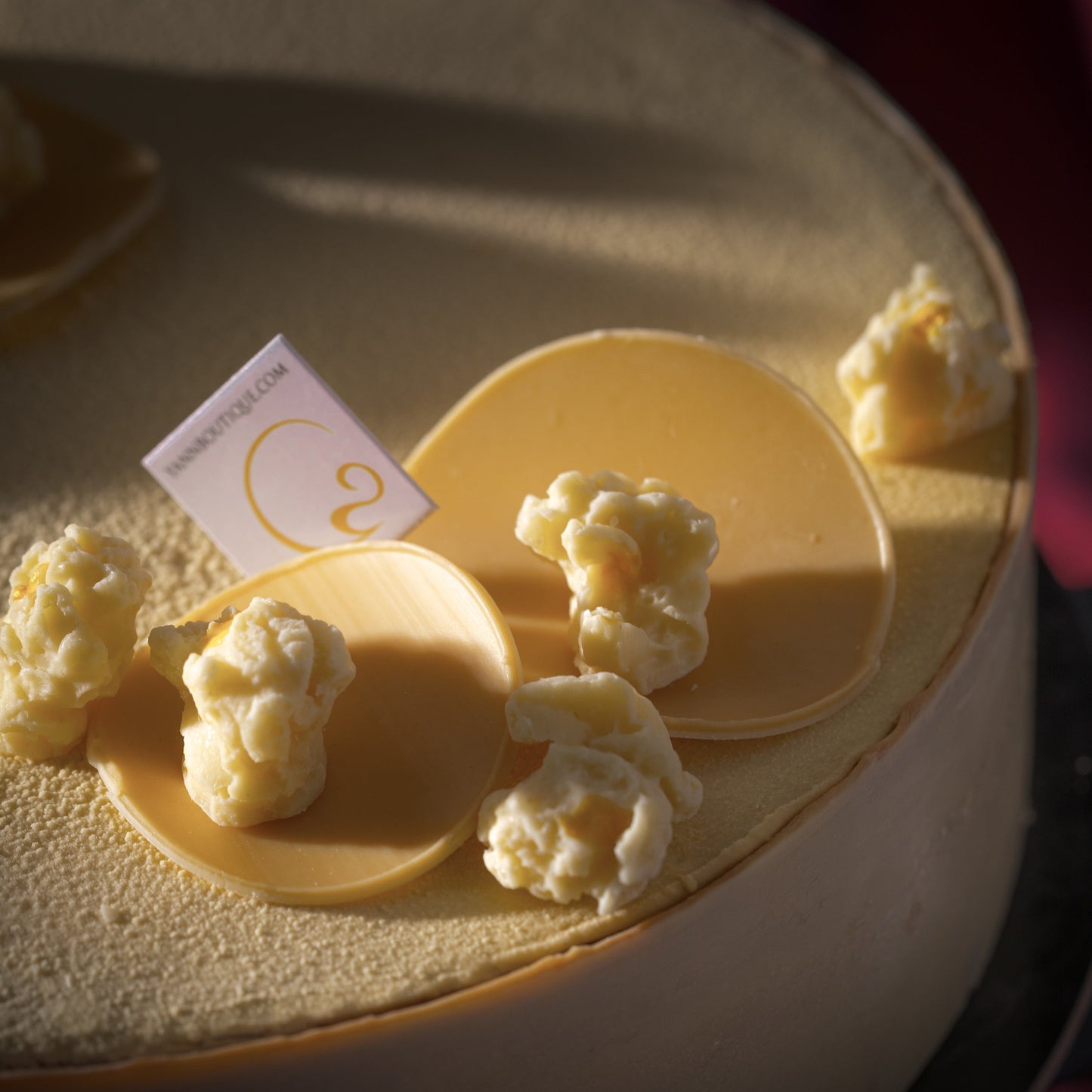 Limited-time Father's Day dessert by Yann Haute Patisserie with corn crunch, silky corn cremeux, single-origin chocolate bavaroise, and elegant white chocolate velvet coating.