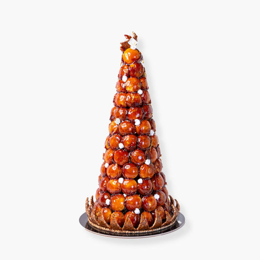 Croquembouche made with cream-filled choux pastries arranged in a traditional French celebration tower