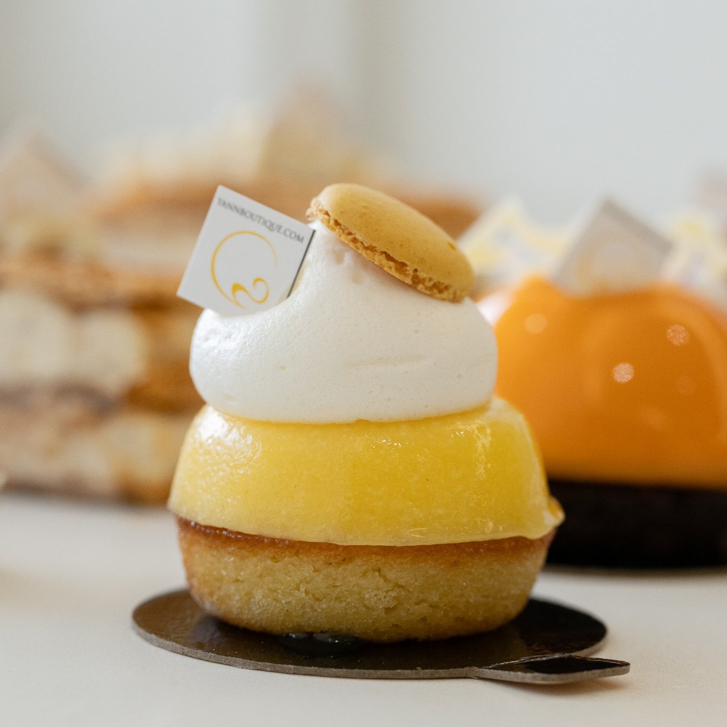 Bright lemon tart featuring almond and lemon cake with crushed lemon compote and meringue