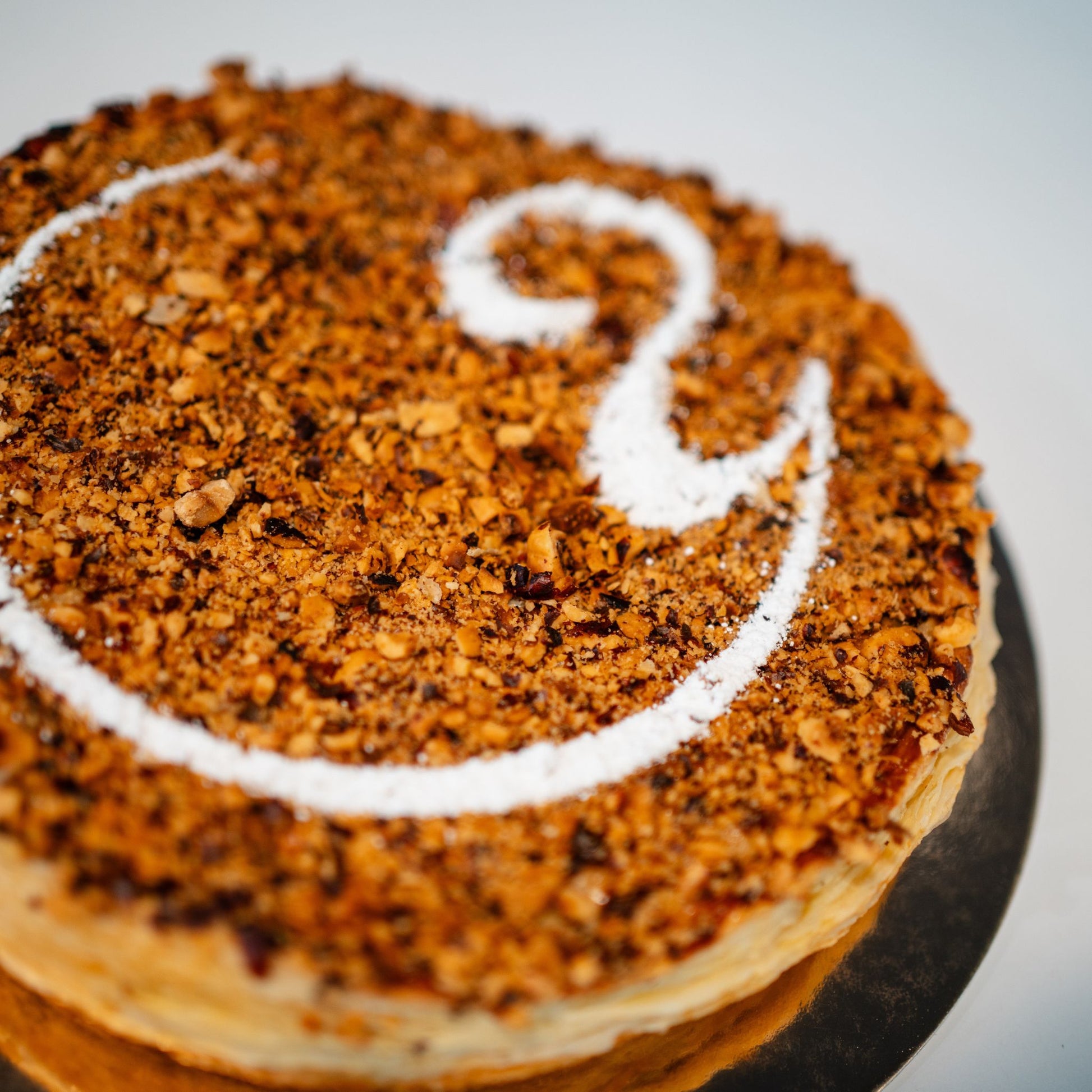 Our Galette des Rois is the perfect treat! This flaky, buttery French pastry, filled with rich hazelnut filling, comes with a hidden fève (charm). Whoever finds it gets to wear the crown and be king or queen for the day!