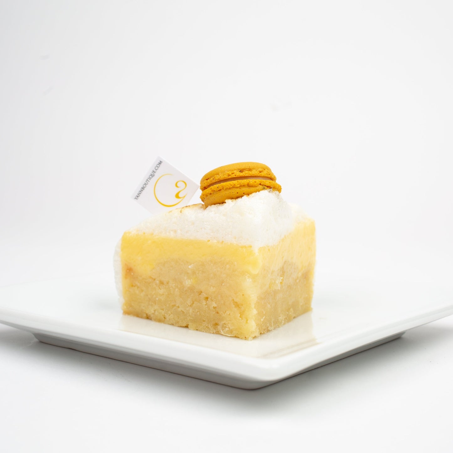 Gluten-free lemon dessert made with almond cake, lemon crémeux, and fluffy lemon meringue