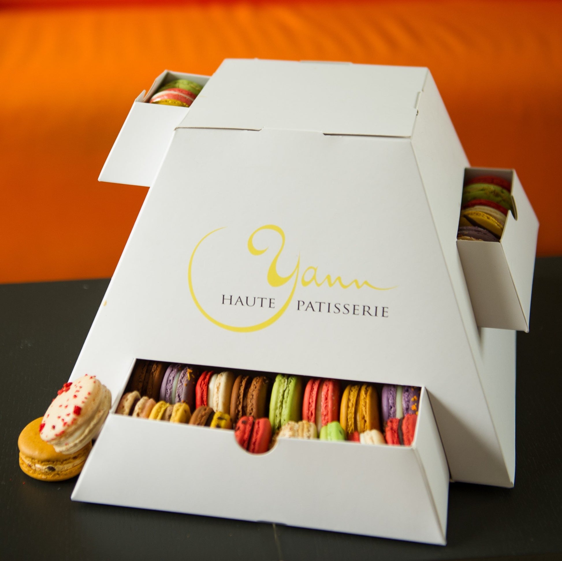 A pyramid of macarons for the best gift ever from Yann Haute Patisserie! Yann Haute Patisserie, authentic French bakery for the best desserts, cakes, croissants and macarons in this happy yellow house pastry shop. 